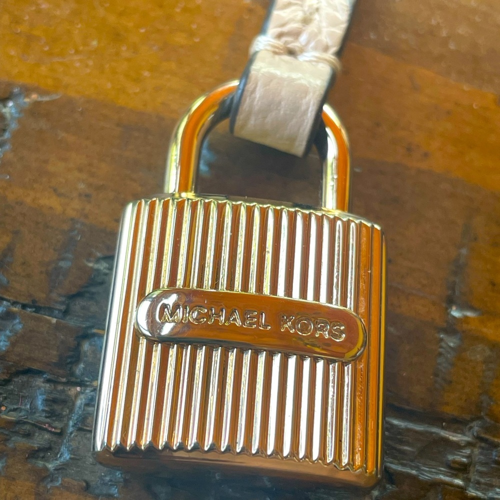 Michael Kors gold tone bag charm